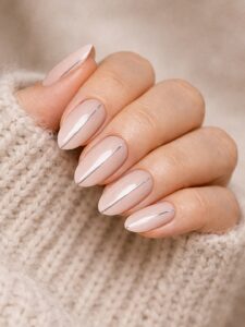 Minimal winter nails in blush nude with a thin silver line detail, short almond nails, glossy minimalist design, Blissful Beauty Nail Lounge San Diego