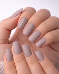 February nails featuring matte taupe manicure with a clean minimalist accent line