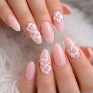 Soft pink almond nails with 3D white floral accents and gold bead details, International Women’s Day Nails at Blissful Beauty Nail Lounge